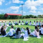 People sitting in circle on the grass