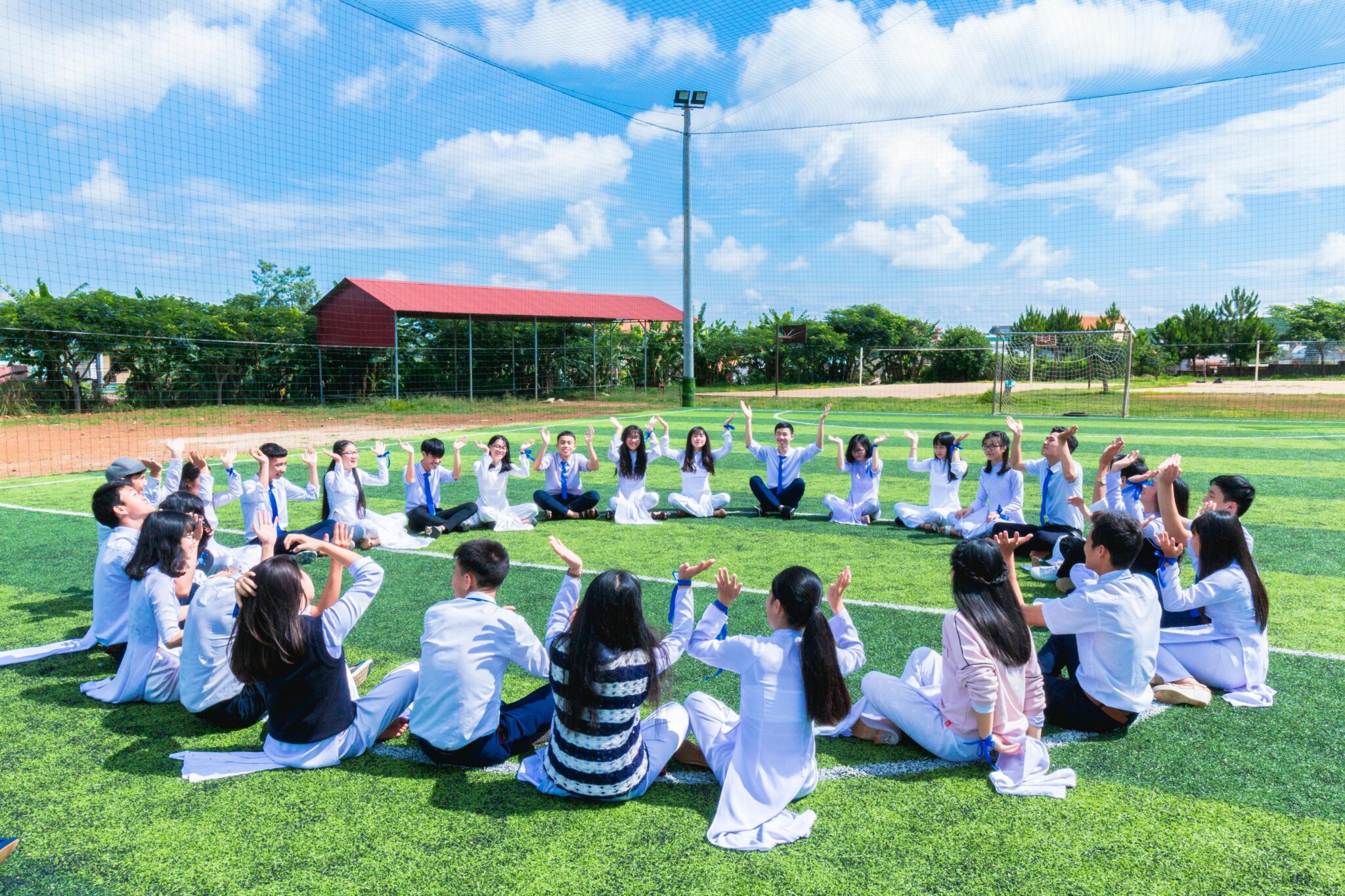 People sitting in circle on the grass